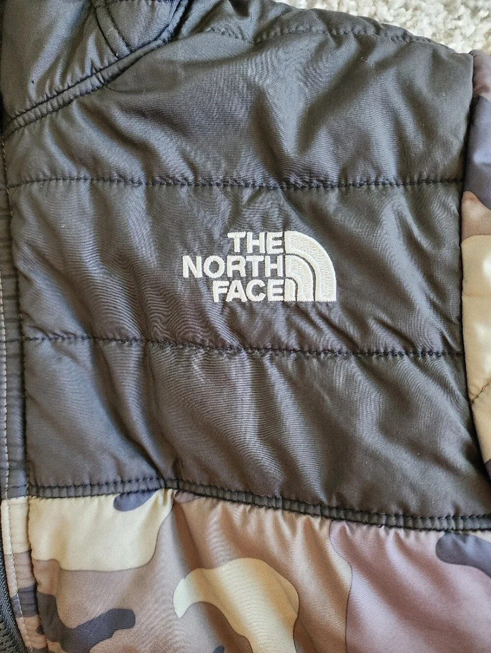 The North Face Camouflage Puffer Jacket in Black and Olive YOUTH